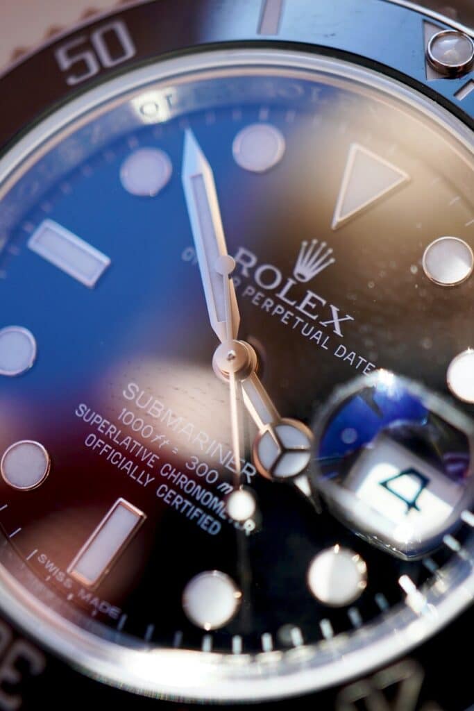 Extreme macro close-up of a Rolex Submariner dial showing the crisp lettering and sapphire crystal.